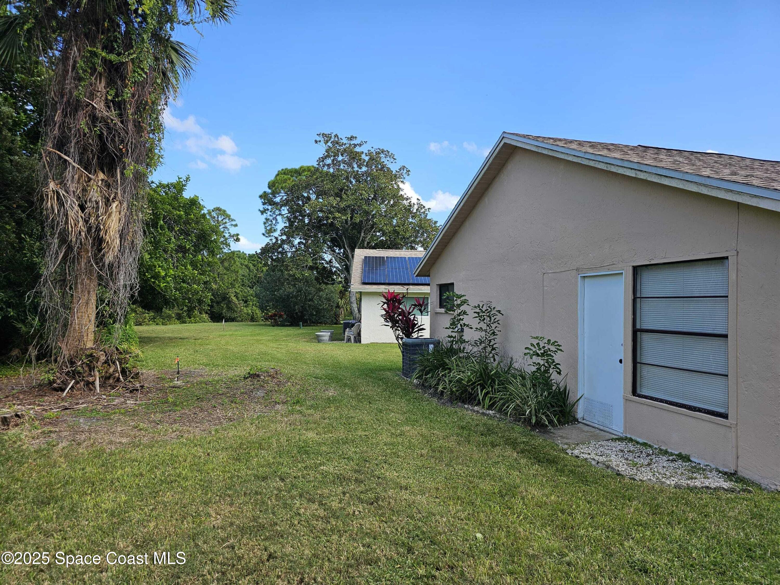 391 Cypress Point Drive Melbourne, FL 32940 - Photo 26 of 28 a view of a house with backyard and garden