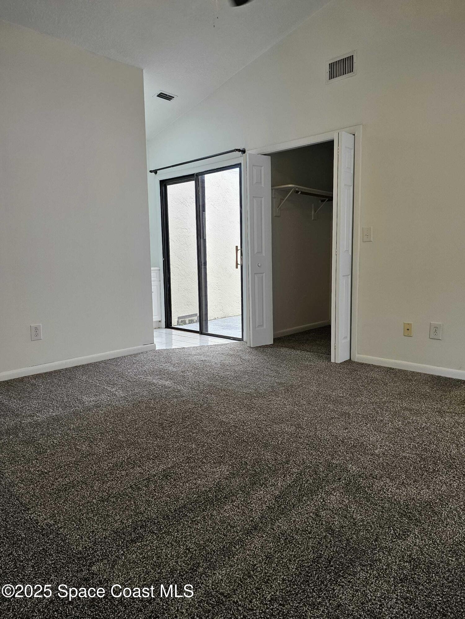 391 Cypress Point Drive Melbourne, FL 32940 - Photo 7 of 28 a view of an empty room with closet and a window