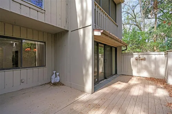 a view of a house with a wooden bench