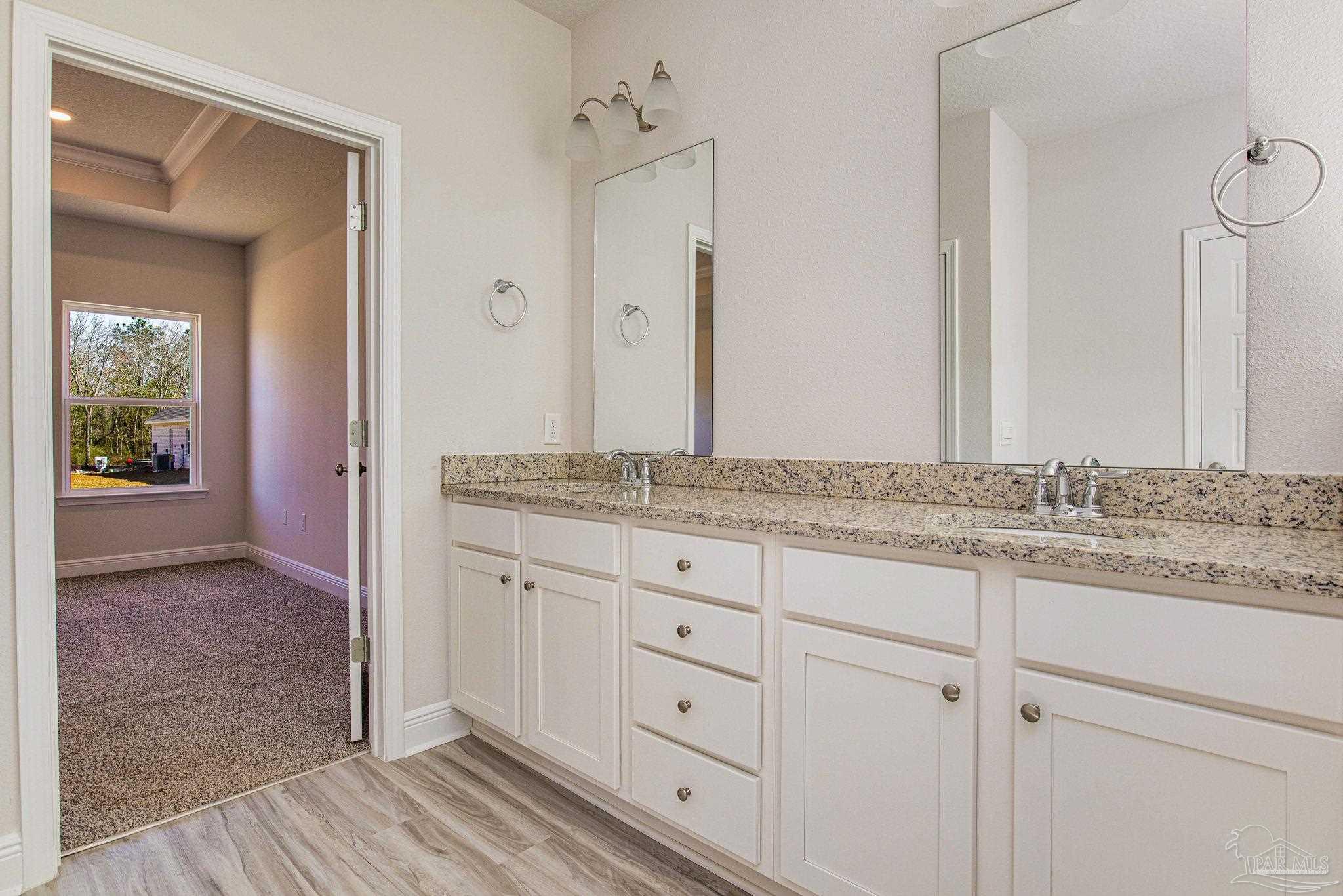 3152 Silver Maple Drive Cantonment, FL 32533 - Photo 19 of 25 a bathroom with a granite countertop sink and a mirror