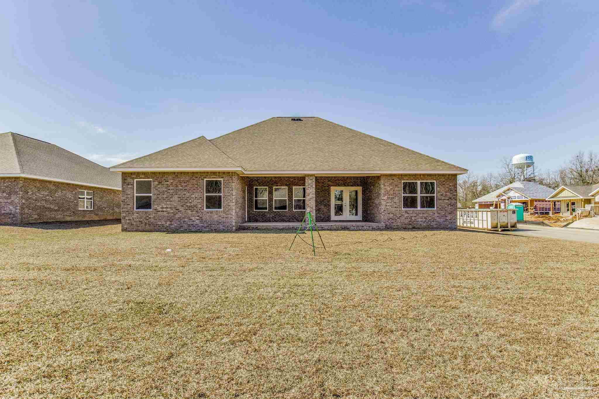 3152 Silver Maple Drive Cantonment, FL 32533 - Photo 21 of 25 a front view of a house with a garden