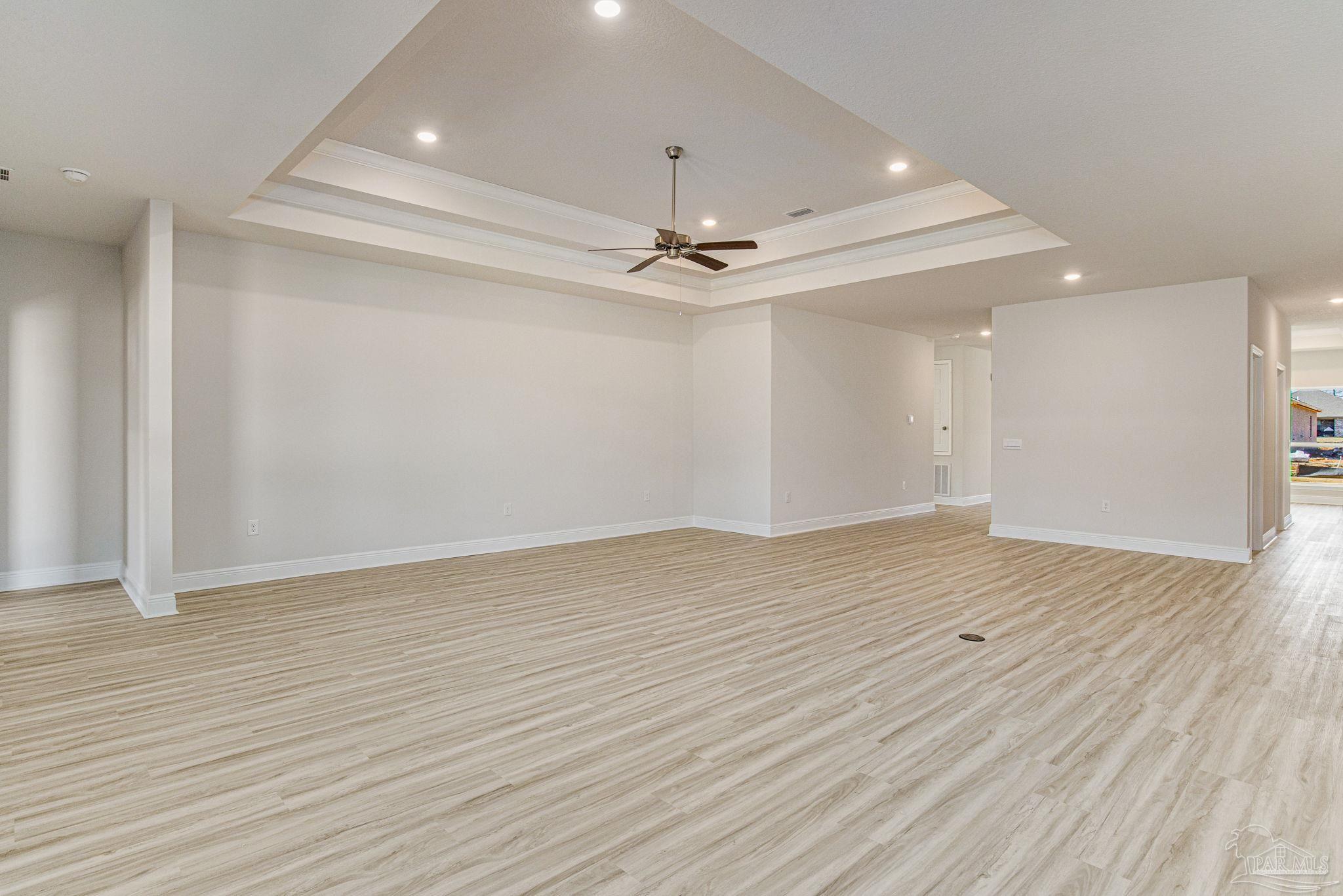 3152 Silver Maple Drive Cantonment, FL 32533 - Photo 9 of 25 wooden floor in an empty room with a ceiling fan