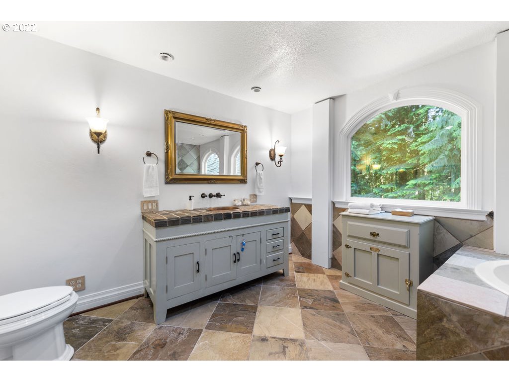 42069 Southeast Erickson Road Sandy, OR 97055 - Photo 16 of 32 a bathroom with a granite countertop sink toilet and mirror