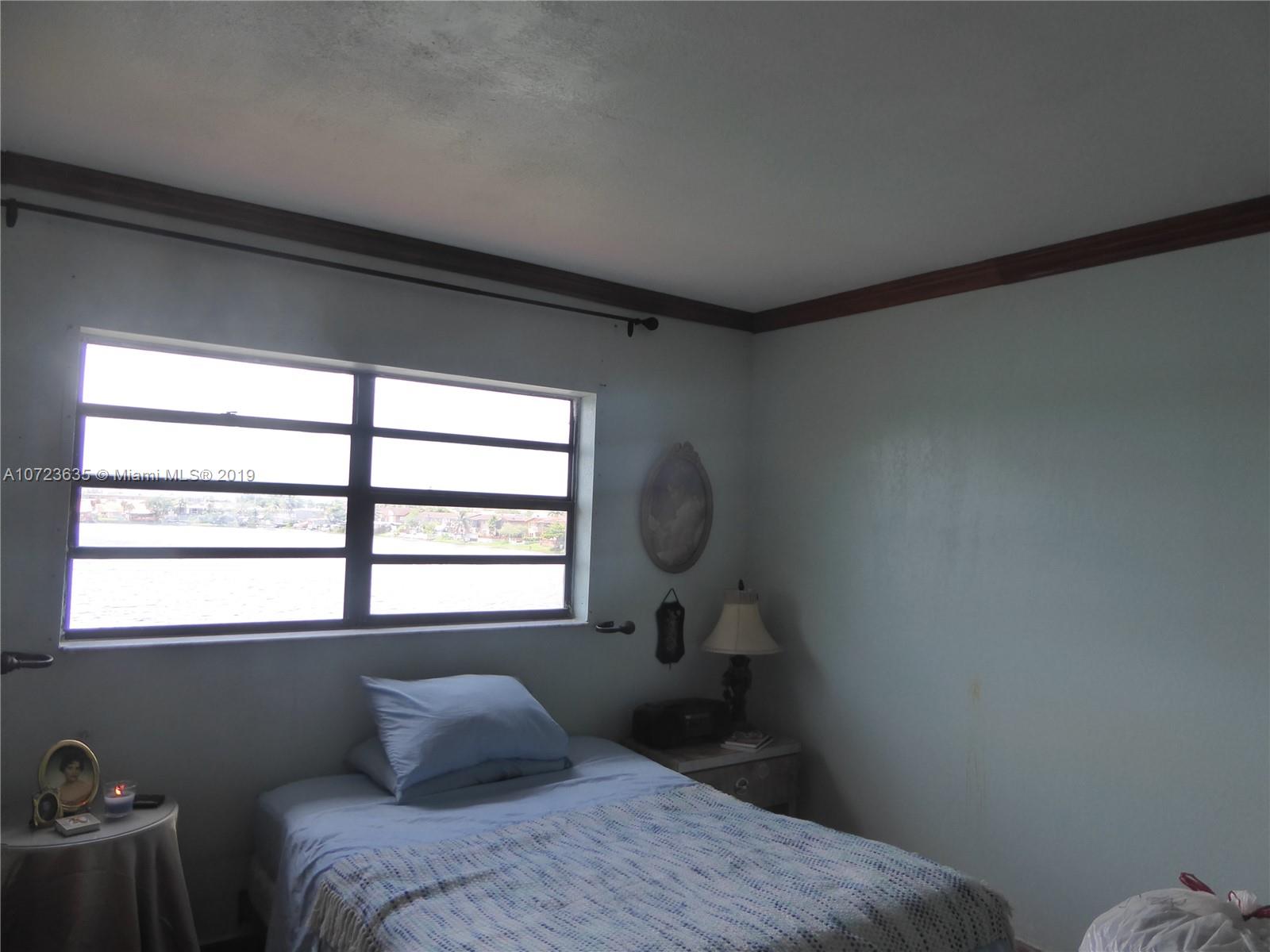 2726 West 60th Street, Unit 68 Hialeah, FL 33016 - Photo 15 of 23 a bedroom with a bed and a window