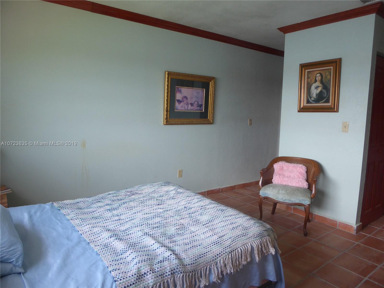 2726 West 60th Street, Unit 68 Hialeah, FL 33016 - Photo 16 of 23 a bedroom with a bed and painting on the wall