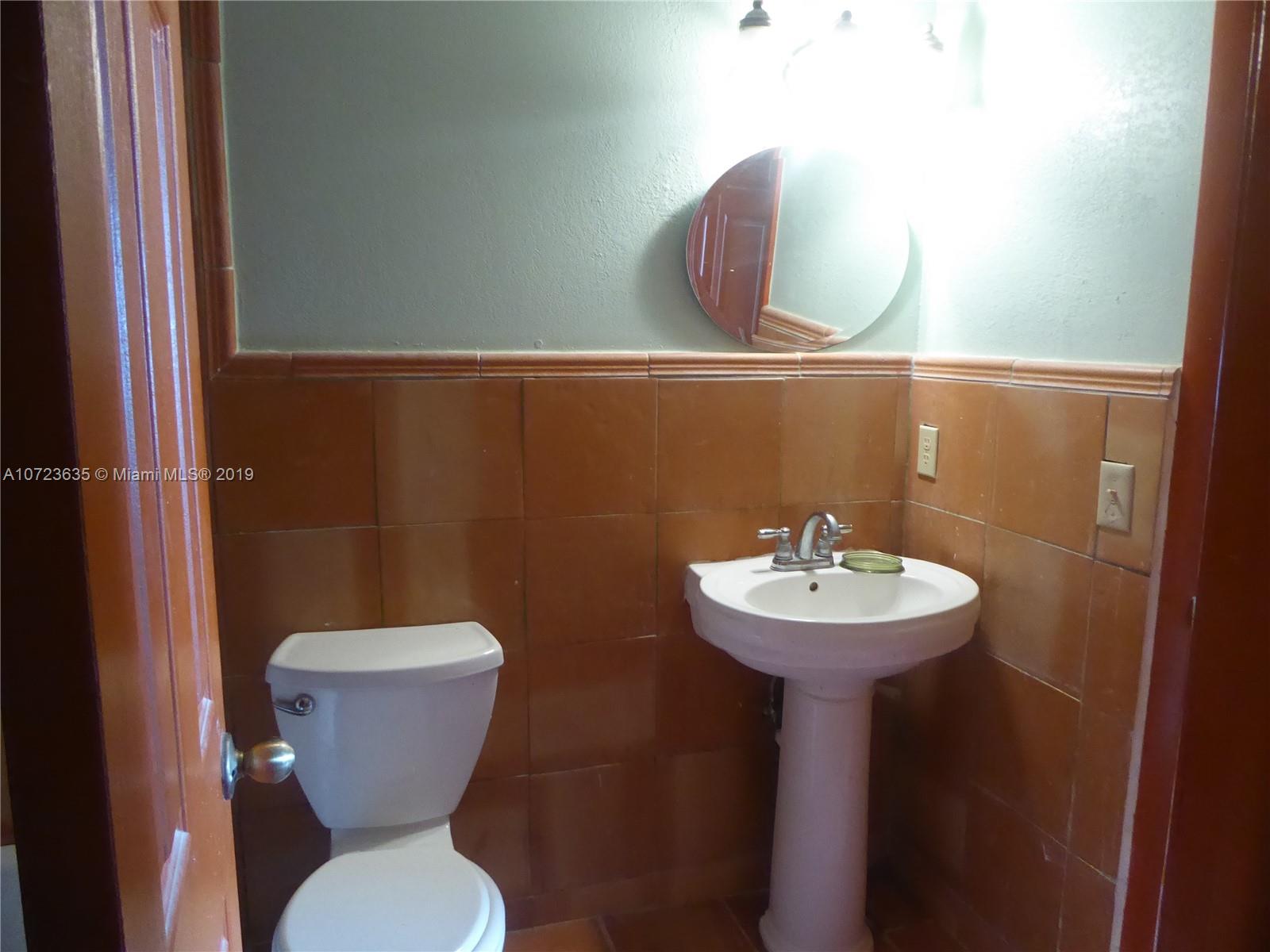 2726 West 60th Street, Unit 68 Hialeah, FL 33016 - Photo 18 of 23 a bathroom with a toilet sink and mirror