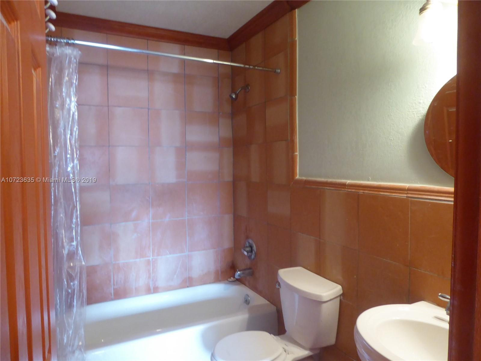 2726 West 60th Street, Unit 68 Hialeah, FL 33016 - Photo 19 of 23 a white toilet sitting next to a bath tub