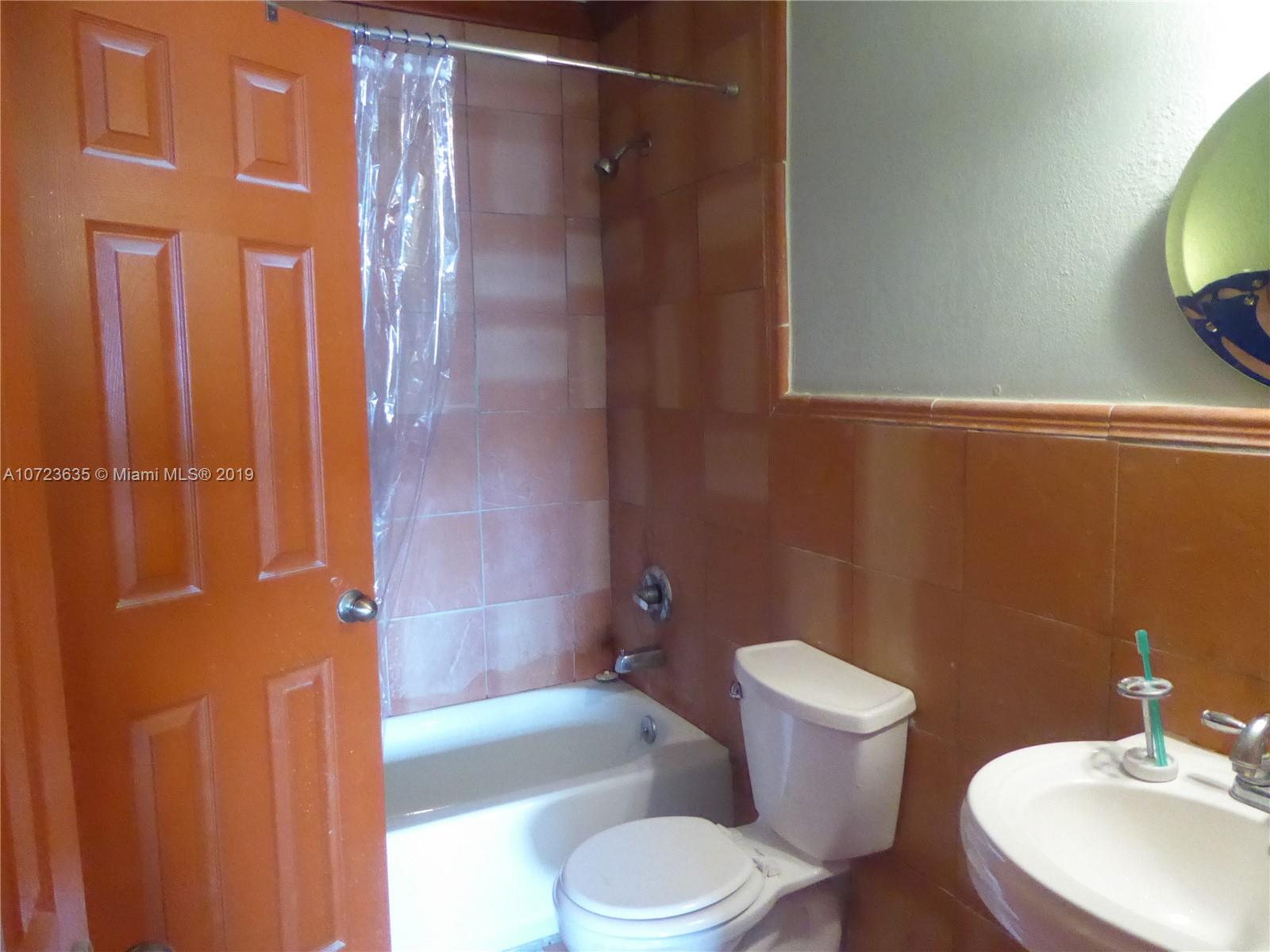 2726 West 60th Street, Unit 68 Hialeah, FL 33016 - Photo 20 of 23 a bathroom with a toilet and shower