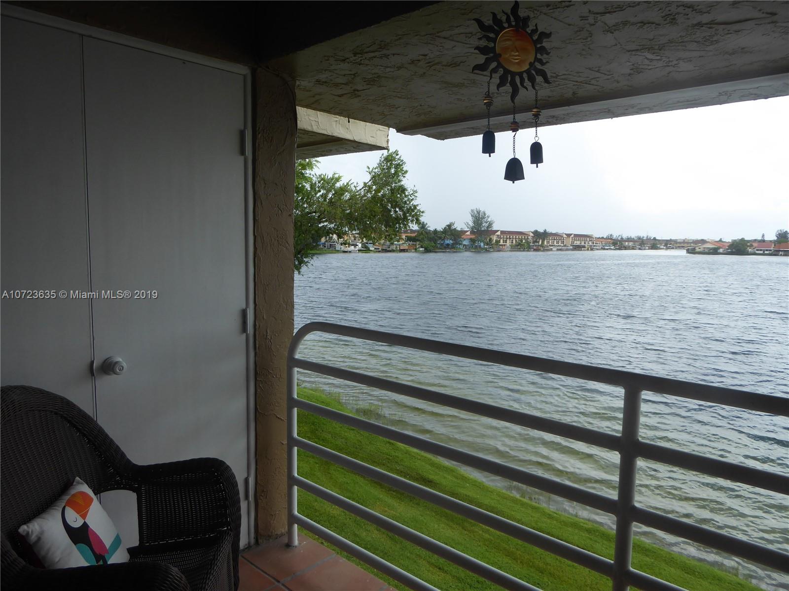 2726 West 60th Street, Unit 68 Hialeah, FL 33016 - Photo 2 of 23 a view of a balcony with chair and wooden floor