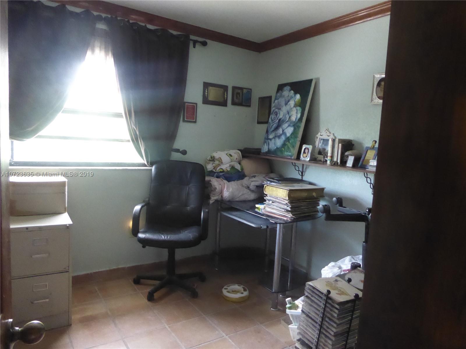 2726 West 60th Street, Unit 68 Hialeah, FL 33016 - Photo 21 of 23 a living room with furniture and a chair