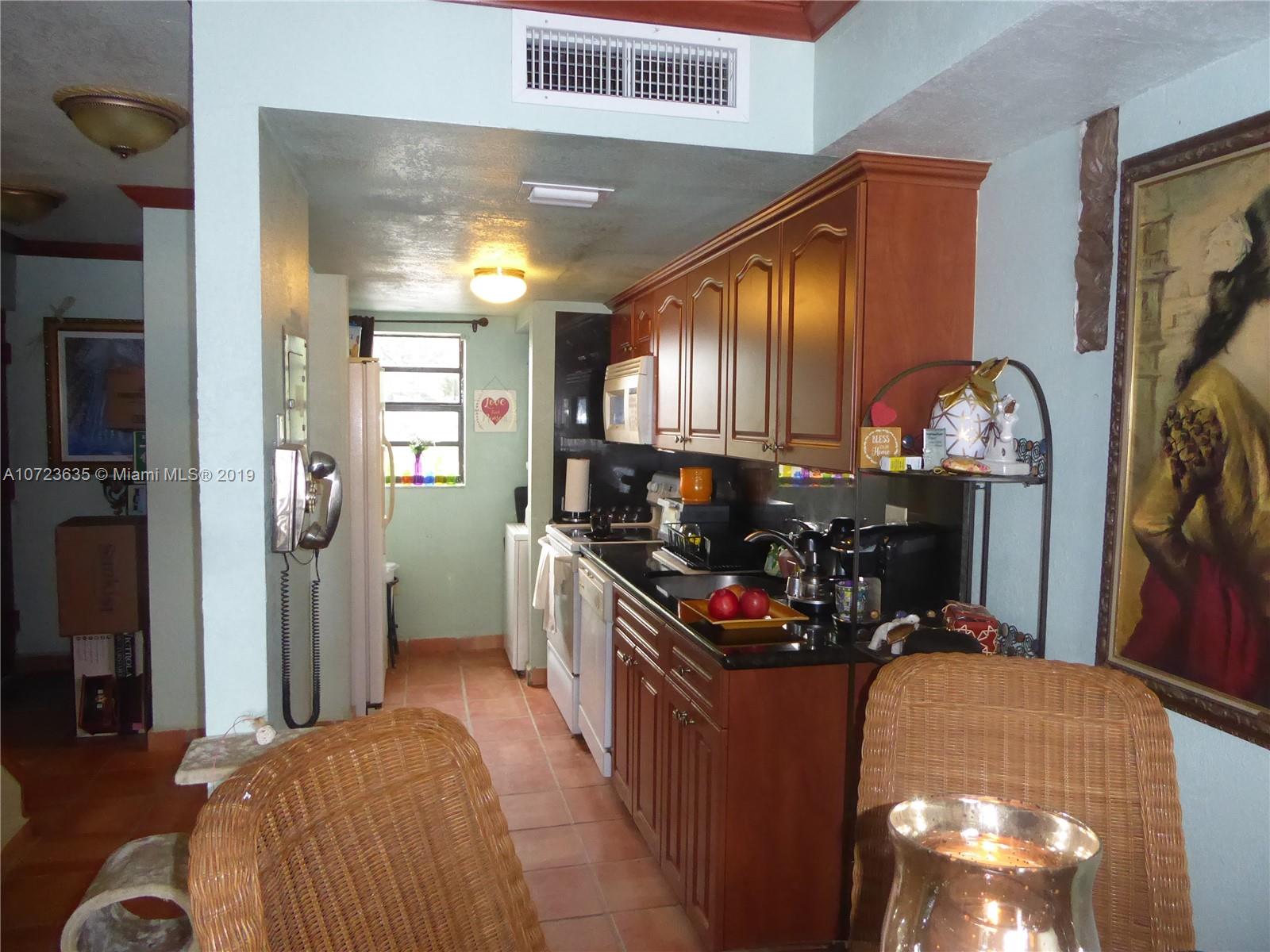 2726 West 60th Street, Unit 68 Hialeah, FL 33016 - Photo 6 of 23 a bedroom with bed and a mirror