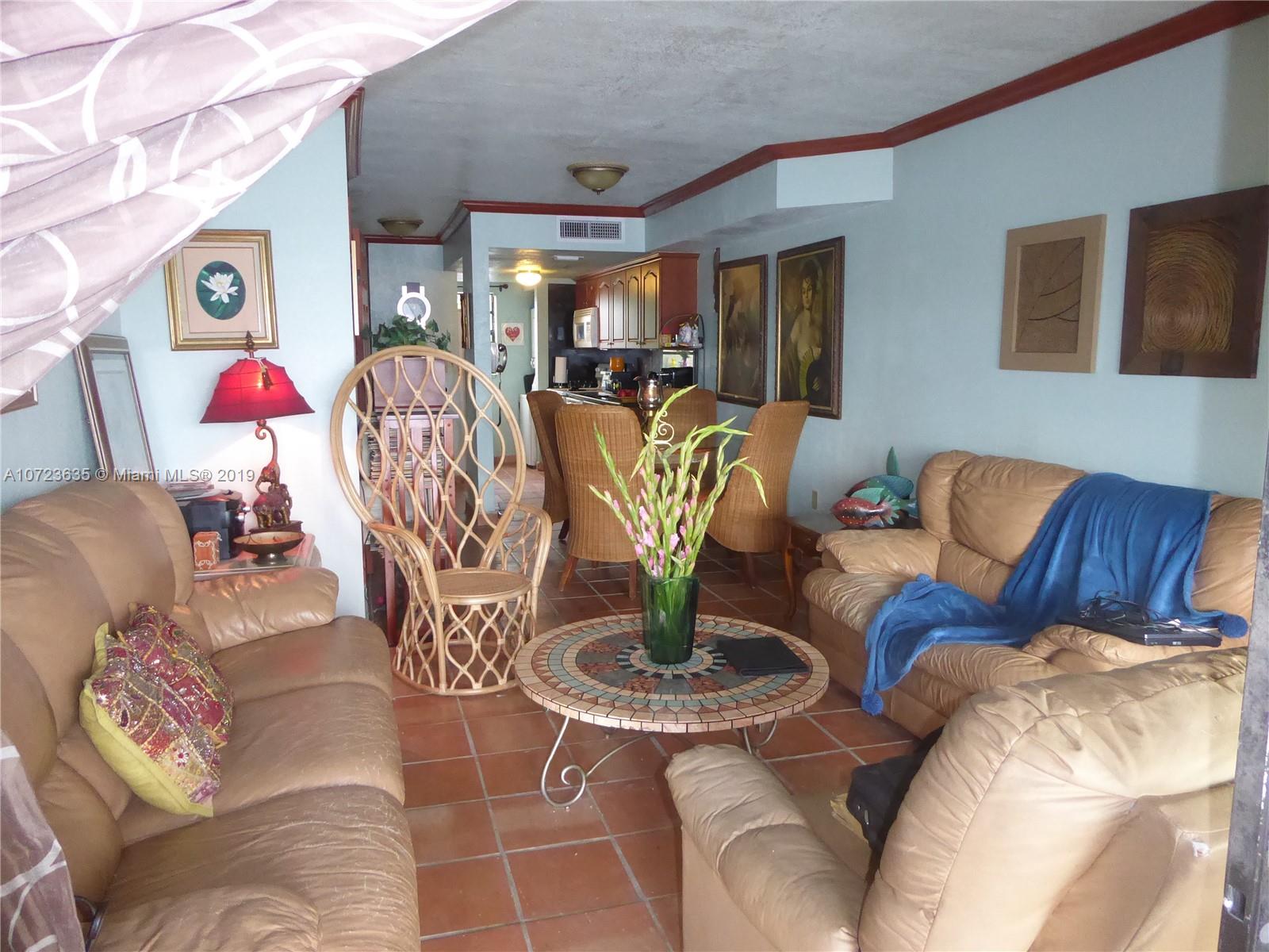 2726 West 60th Street, Unit 68 Hialeah, FL 33016 - Photo 7 of 23 a living room with patio furniture and wooden floor