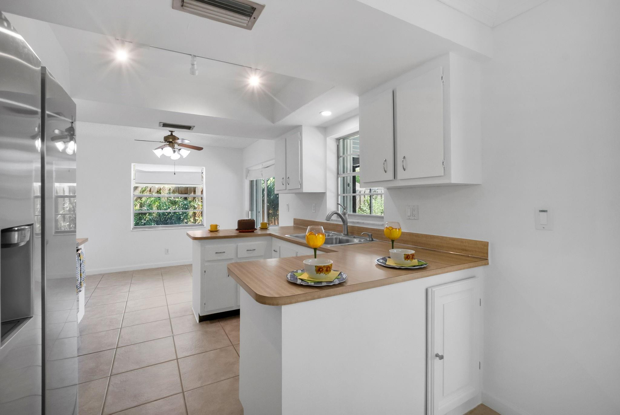 22750 Southwest 56th Avenue Boca Raton, FL 33433 - Photo 5 of 28 Kitchen with pass thru to patio.