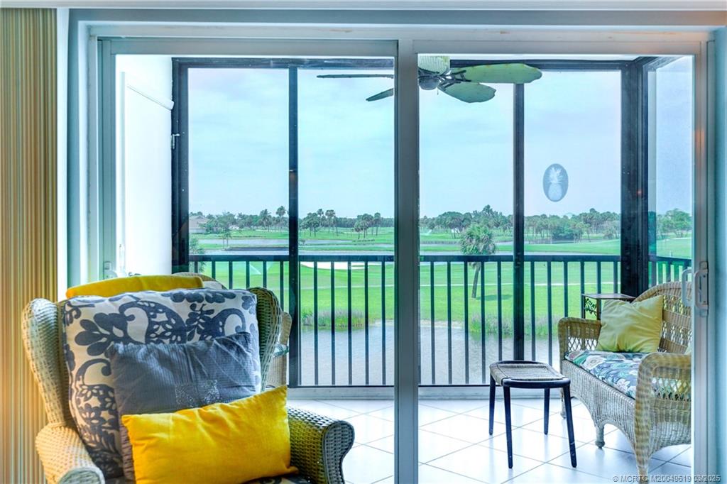 40 Northeast Plantation Road, Unit 311 Stuart, FL 34996 - Photo 13 of 19 a living room with furniture and a large window