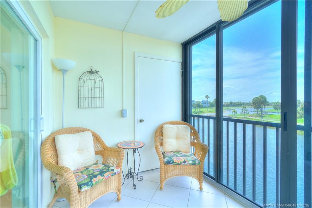 40 Northeast Plantation Road, Unit 311 Stuart, FL 34996 - Photo 15 of 19 a view of a balcony with chair and potted plant