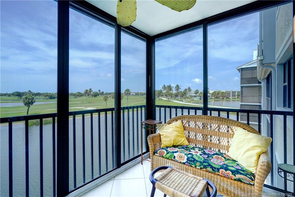 40 Northeast Plantation Road, Unit 311 Stuart, FL 34996 - Photo 17 of 19 a view of a balcony with chairs and a table