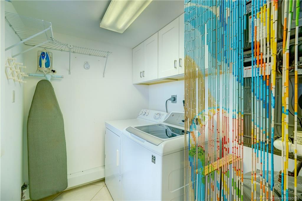 40 Northeast Plantation Road, Unit 311 Stuart, FL 34996 - Photo 4 of 19 a utility room with dryer and washer