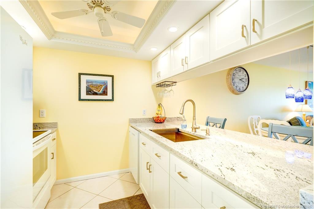 40 Northeast Plantation Road, Unit 311 Stuart, FL 34996 - Photo 6 of 19 a bathroom with a granite countertop double vanity sink and a mirror