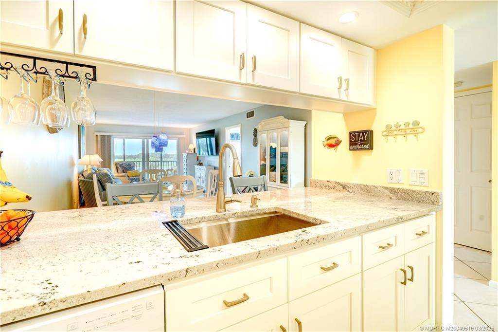 40 Northeast Plantation Road, Unit 311 Stuart, FL 34996 - Photo 7 of 19 a bathroom with a sink and a mirror