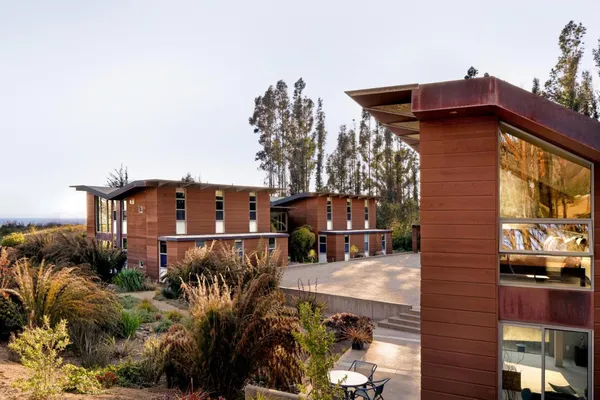 a living room with furniture and floor to ceiling windows