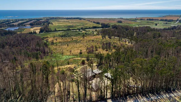 an aerial view of a house with balcony and outdoor space