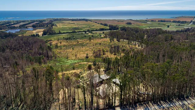 an aerial view of a house with balcony and outdoor space