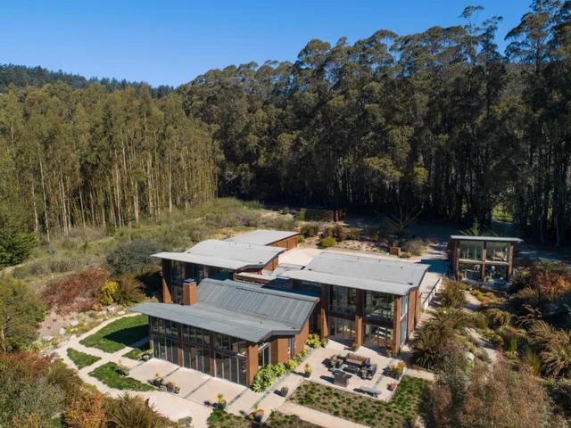 an aerial view of a house with a yard basket ball court and outdoor seating