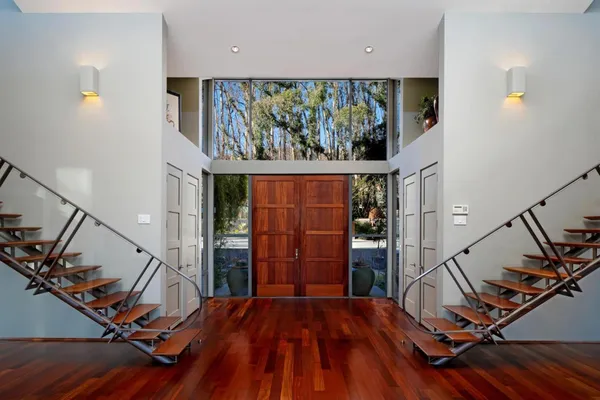 a view of a room with wooden floor and windows