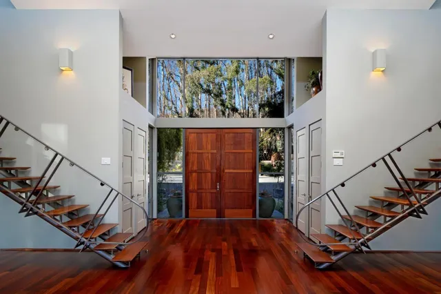 a view of a room with wooden floor and windows