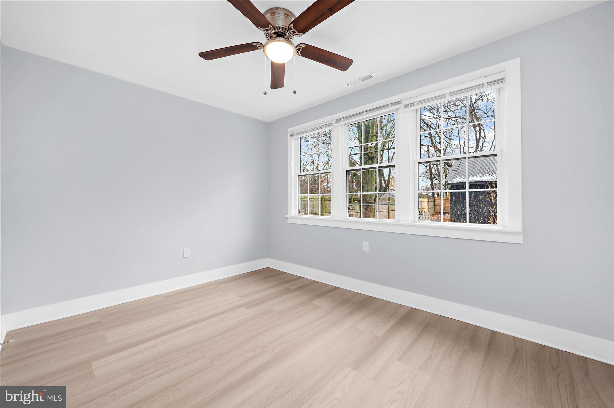 733 West County Line Road Horsham, PA 19044 - Photo 19 of 24 a view of an empty room with wooden floor and a window