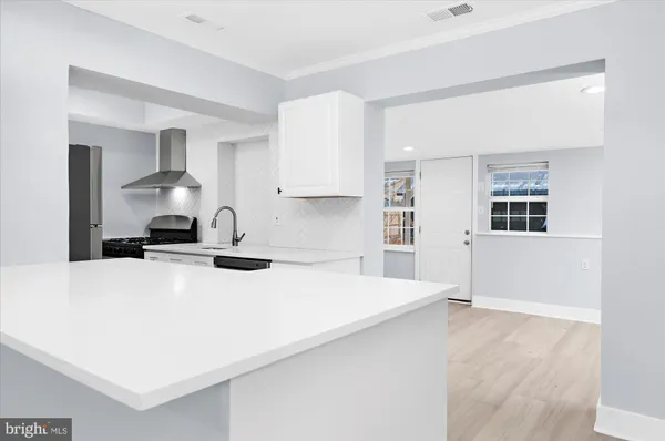 a kitchen with a stove a sink and a refrigerator
