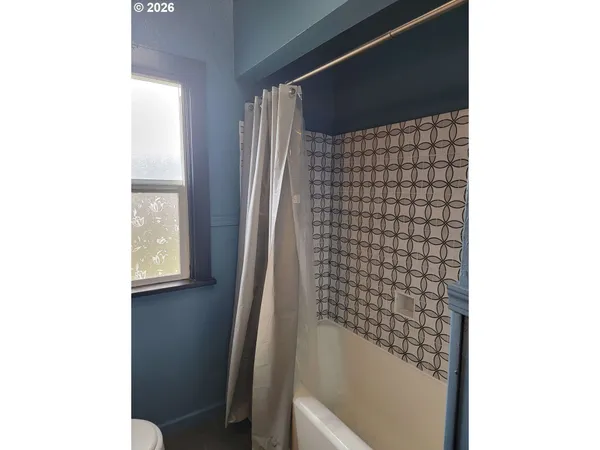 a view of a bathroom with a sink and a mirror