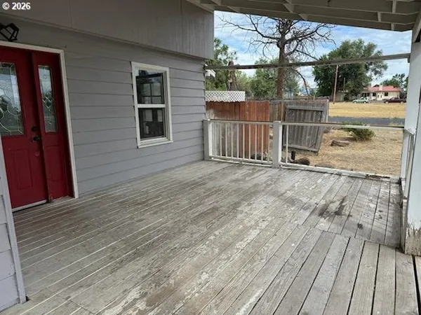 a view of backyard with a deck and wooden floor