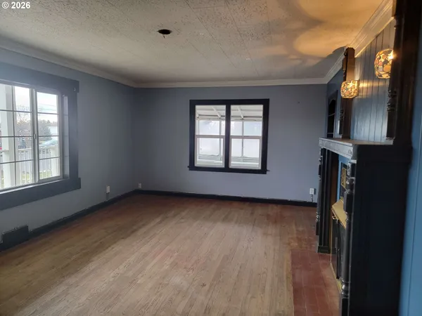 a view of a livingroom with wooden floor and a window