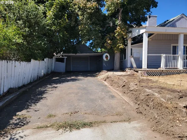 a view of a backyard with wooden fence