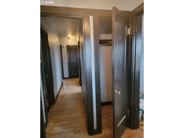 a view of a hallway with wooden floor