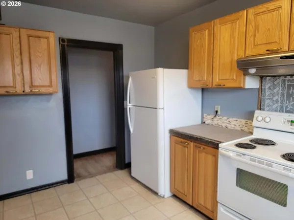 a kitchen with a refrigerator and a stove
