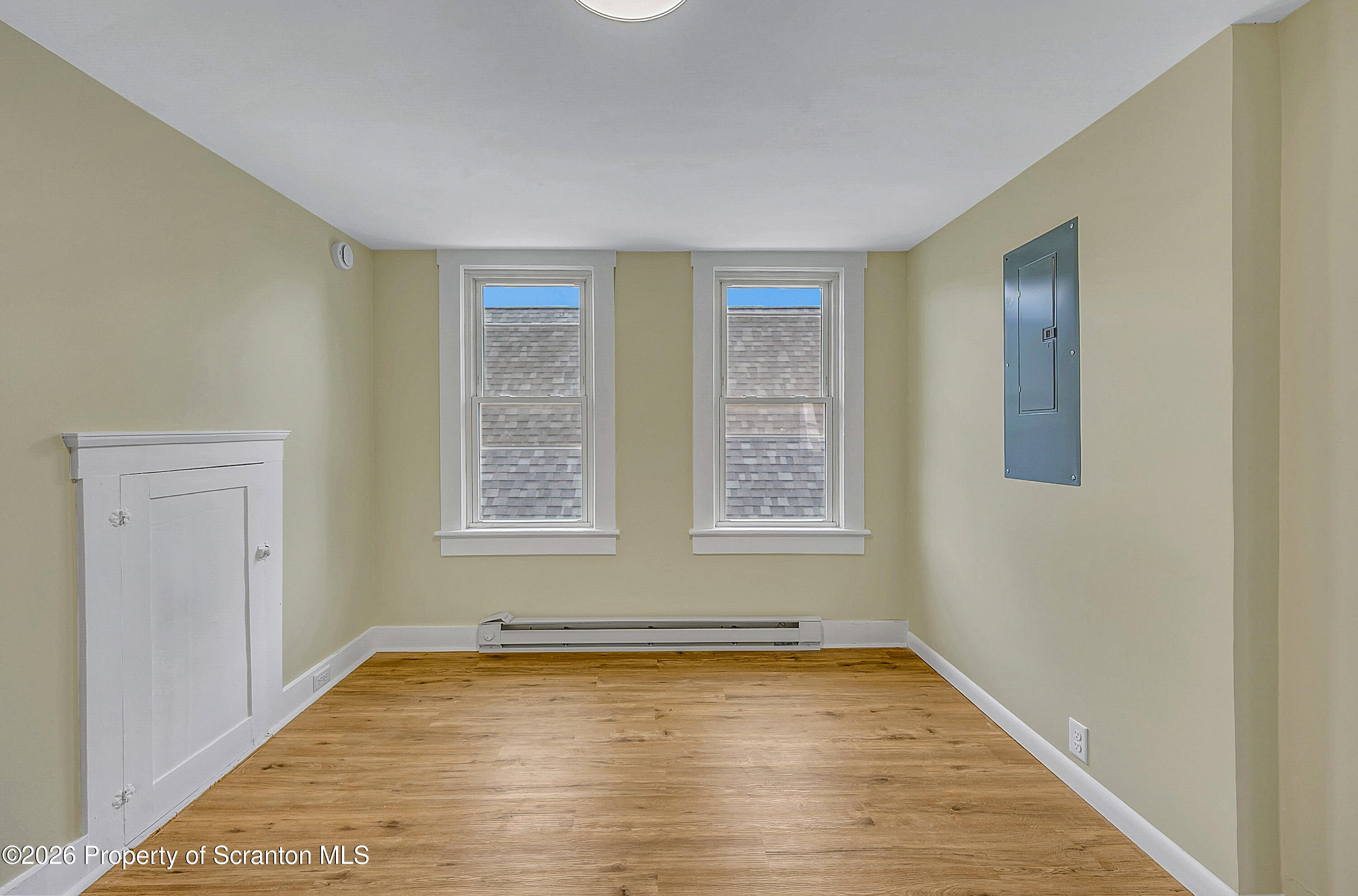 529 Wheeler Avenue, Unit 2 Scranton, PA 18510 - Photo 4 of 12 a view of an empty room with wooden floor and a window