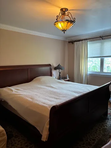 a bedroom with a bed and a chandelier