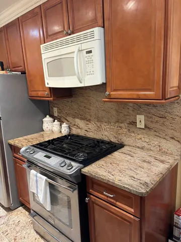a stove top oven sitting inside of a kitchen