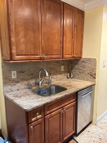 a kitchen with granite countertop stainless steel appliances a sink and a counter top