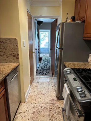 a kitchen with granite countertop a refrigerator and a stove