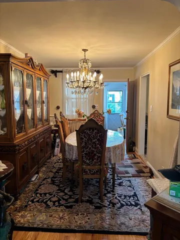a dining room with furniture a rug and wooden floor