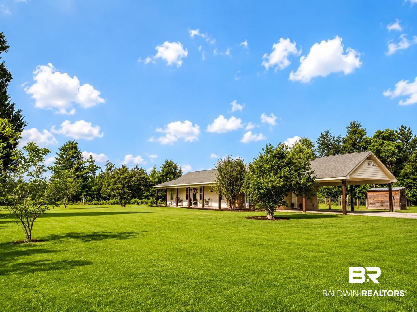 21733 Sedlack Road Silverhill, AL 36576 - Photo 5 of 22 Spacious property featuring a single-story residence with a covered front porch, an attached carport, and a separate outbuilding
