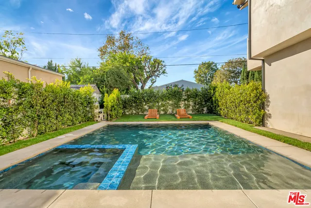 a spacious bedroom with a large bed and a couch