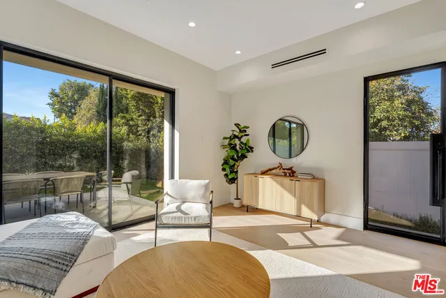 a view of a chairs and table in the back yard of the house