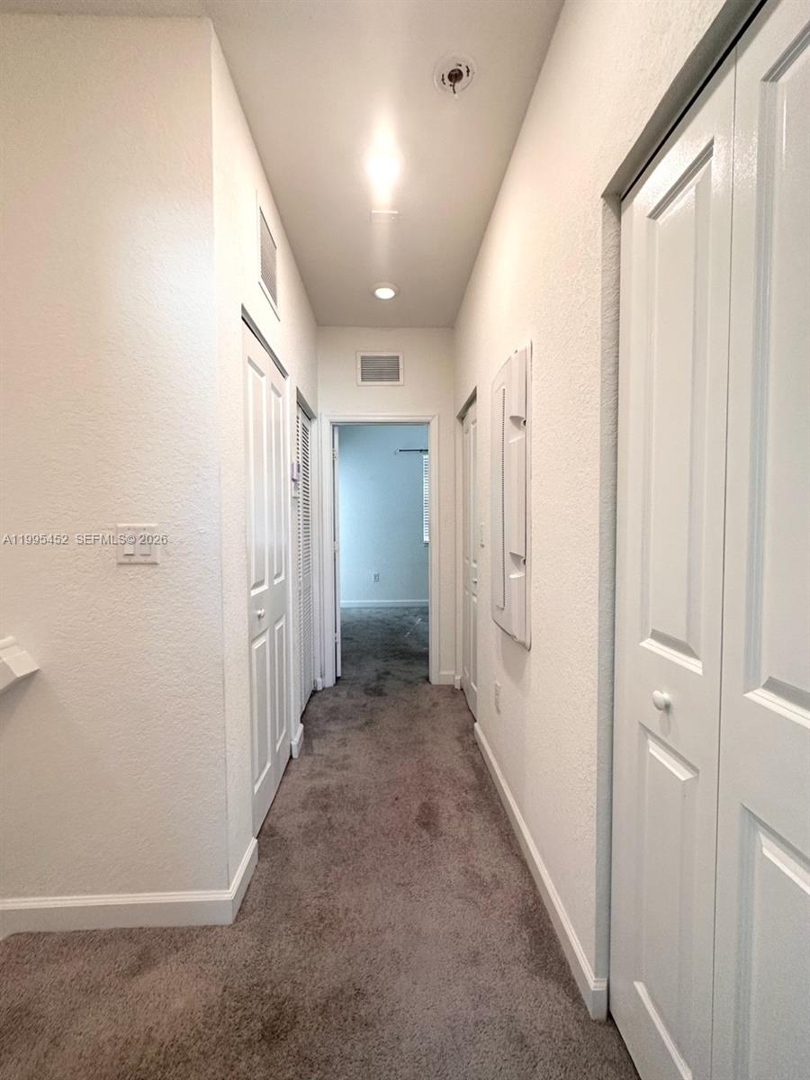 24920 Southwest 112th Court Homestead, FL 33032 - Photo 11 of 48 a view of a hallway with closet area