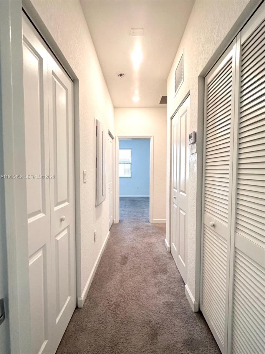 24920 Southwest 112th Court Homestead, FL 33032 - Photo 12 of 48 a view of a hallway with a wooden door