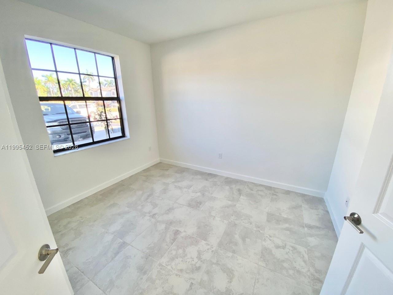 24920 Southwest 112th Court Homestead, FL 33032 - Photo 13 of 48 an empty room with a window