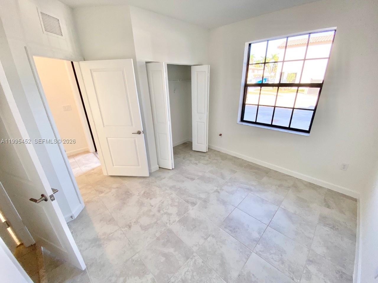 24920 Southwest 112th Court Homestead, FL 33032 - Photo 14 of 48 an empty room with windows and closet